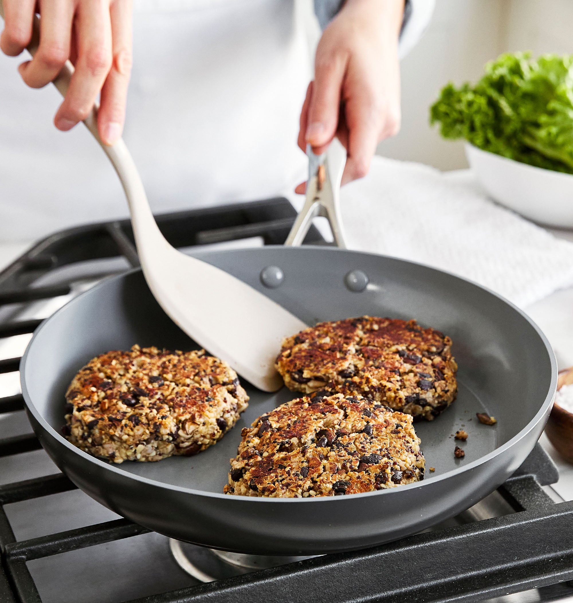 Three black bean and mushroom veggie burgers in a frypan