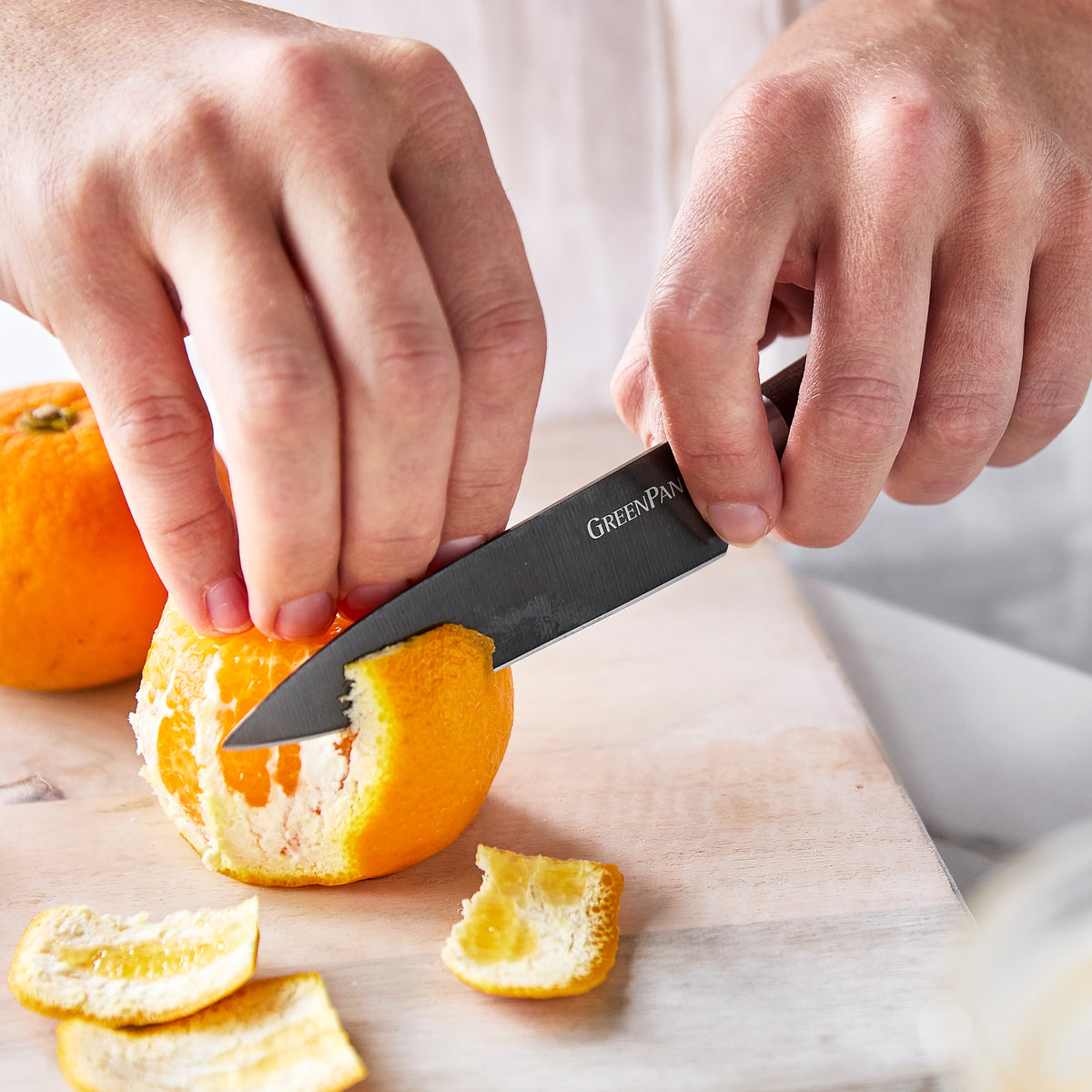 Peeling an orange with a paring knife